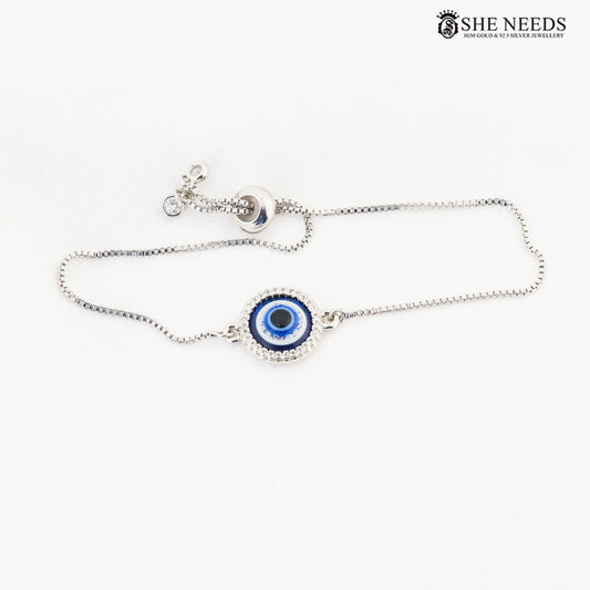 Silver-tone adjustable bracelet featuring a blue evil eye centerpiece, sparkling CZ stone accents, and a sliding adjustable chain on a white background.|She Needs Jewellery
