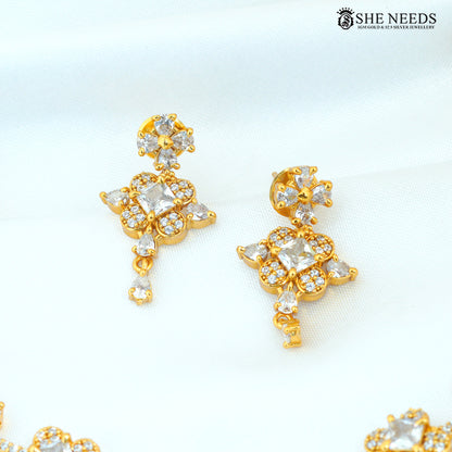 Gold polish floral American Diamond drop earrings with sparkling white stone detailing|She Needs Jewellery
