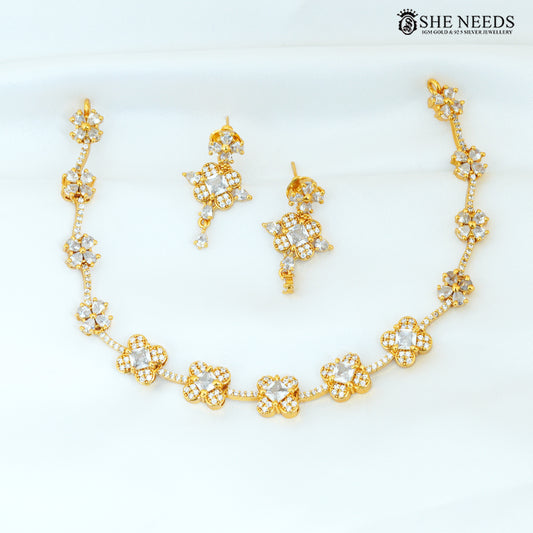 Gold polish floral American Diamond necklace with matching drop earrings and sparkling white stone details|She Needs Jewellery
