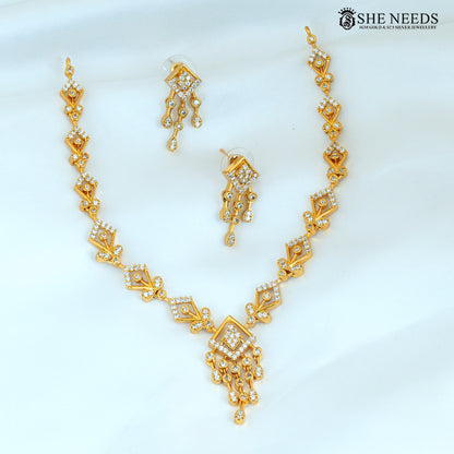 Geometric gold necklace set with matching diamond-studded earrings and statement pendant|She Needs Jewellery
