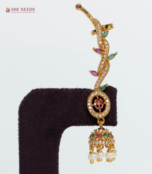 Gold-plated vine ear cuff jhumka earring featuring ruby and emerald-colored stones, sparkling American Diamonds, and pearl drop danglers for bridal and festive wear.|She Needs Jewellery