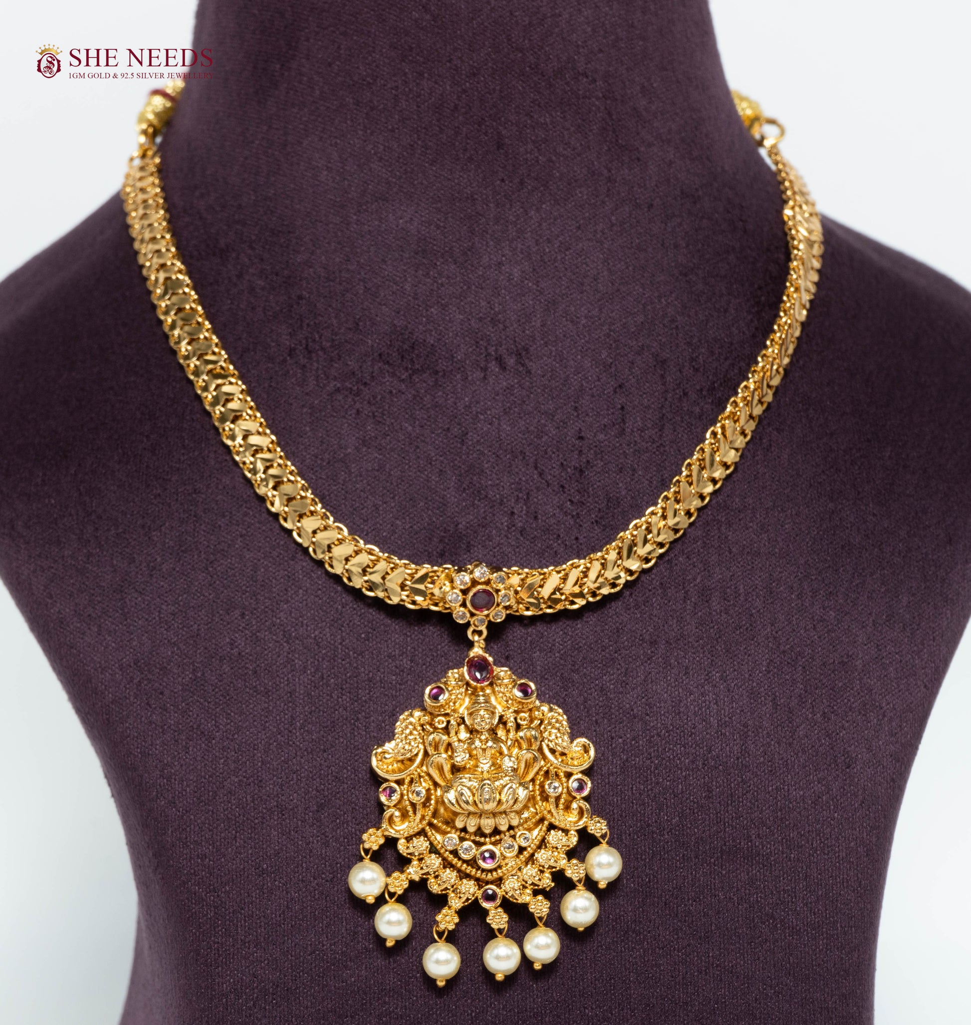Gold-plated Temple Lakshmi necklace featuring a Goddess Lakshmi pendant with pink stones, American Diamonds, pearl drops, and traditional South Indian craftsmanship.|She Needs Jewellery
