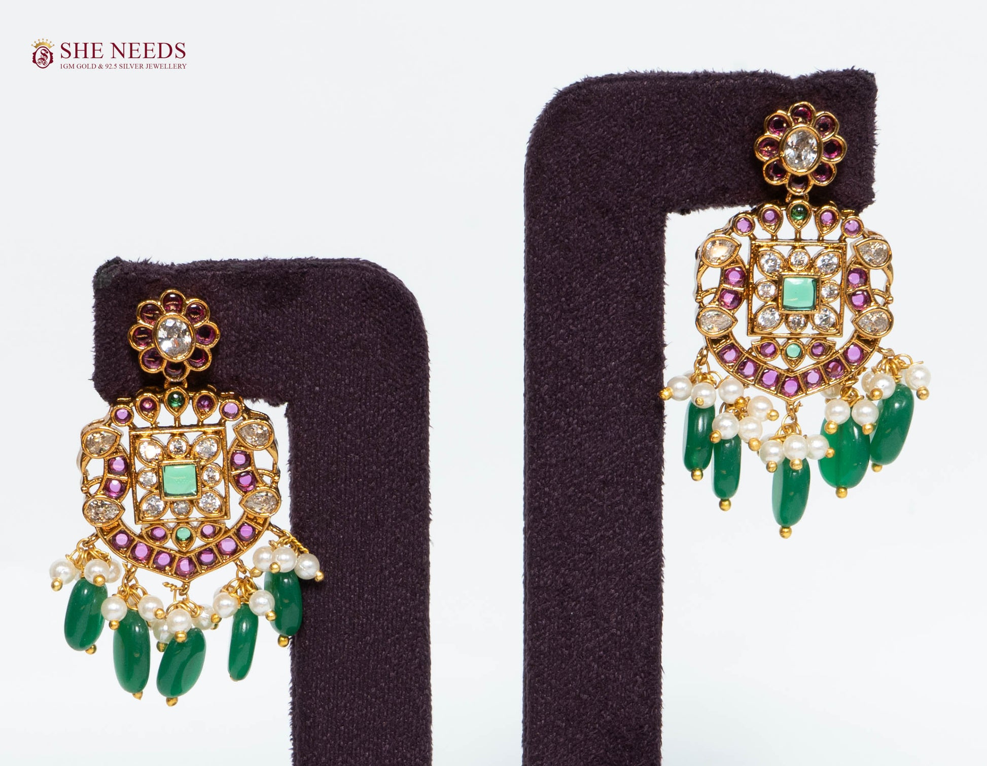 Pair of gold multicolor temple drop earrings featuring American Diamond stones, green bead drops, pink stones, and pearl detailing.|She Needs Jewellery

