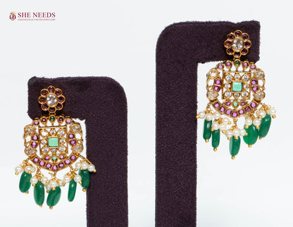 Pair of gold multicolor temple drop earrings featuring American Diamond stones, green bead drops, pink stones, and pearl detailing.|She Needs Jewellery
