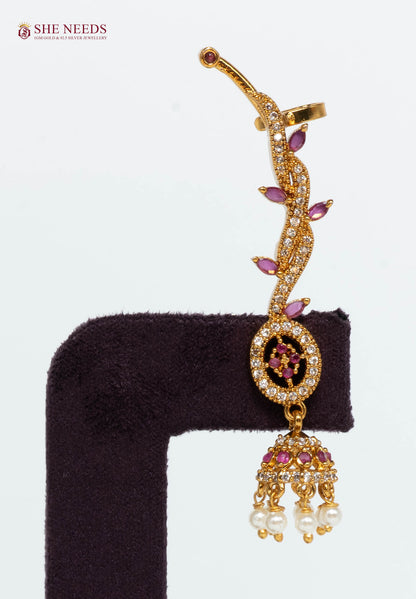 Close-up of a gold-plated pink vine ear cuff jhumka earring featuring AD stones, pink marquise stones, and pearl danglers.|She Needs Jewellery
