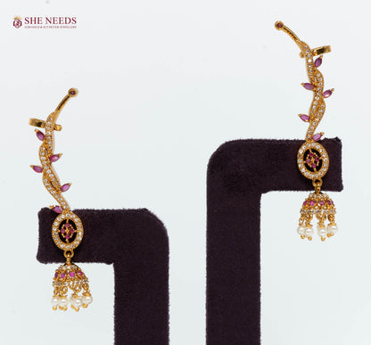 Pair of gold-plated pink vine ear cuff jhumka earrings with sparkling AD stones and pearl danglers for bridal and festive wear.|She Needs Jewellery
