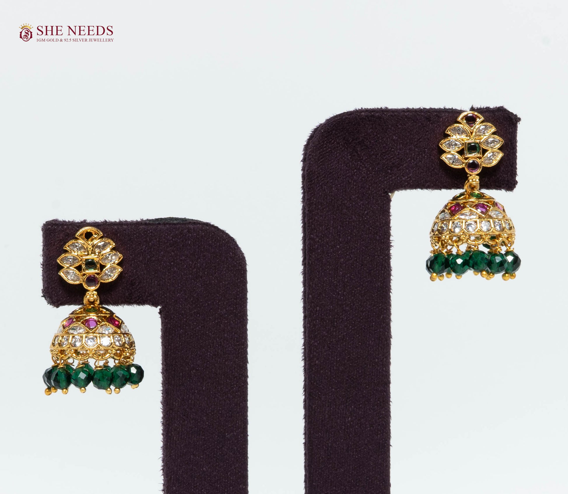 Gold Plated Floral Jhumka Earrings with American Diamonds, Emerald Green Stones and Green Crystal Beads | She Needs Jewellery