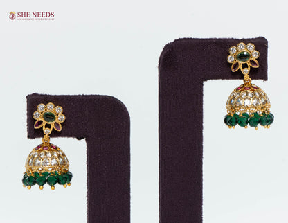 Gold Plated Floral Kundan Jhumka Earrings with American Diamonds, Emerald Green Crystal Beads and Ruby Accents | She Needs Jewellery