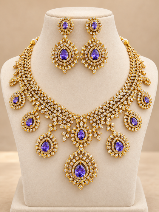 Purple Kamalika AD Floral Choker Necklace Set with gold polish, sparkling white stones, purple teardrop accents and matching drop earrings by She Needs Jewellery.