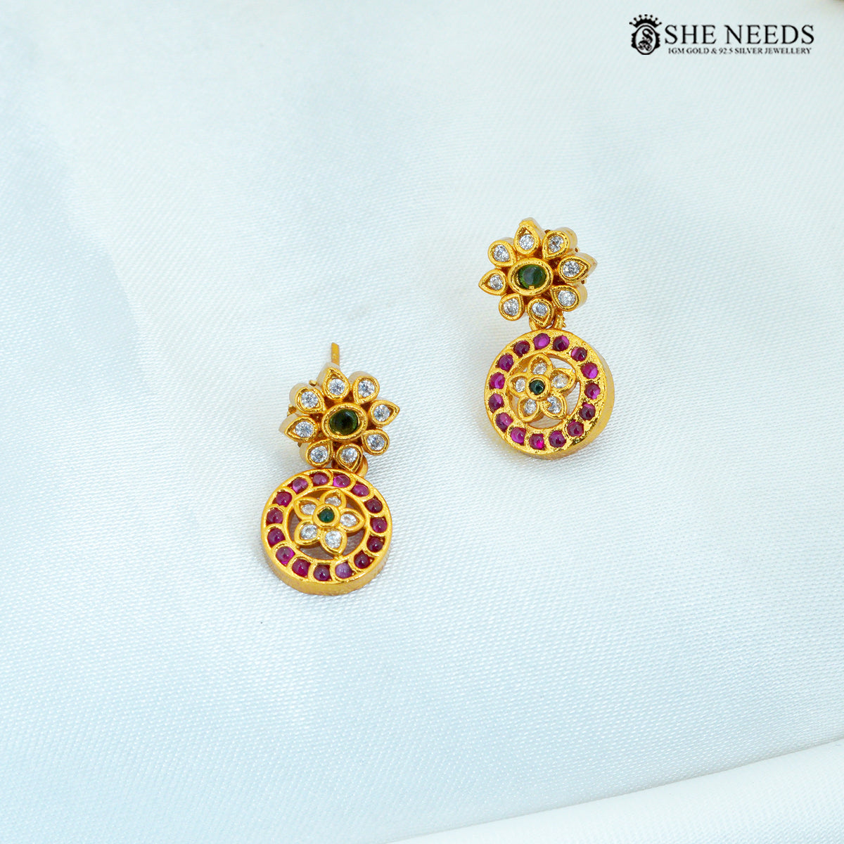 Kamalika matte gold plated floral earrings with American Diamond, ruby and green stone accents|She Needs Jewellery
