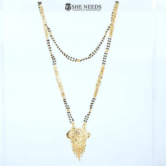 Full view of Kamalini Gold Plated Traditional Mangalsutra with an engraved floral pendant, decorative tassels, and a traditional black bead chain.|She Needs Jewellery
