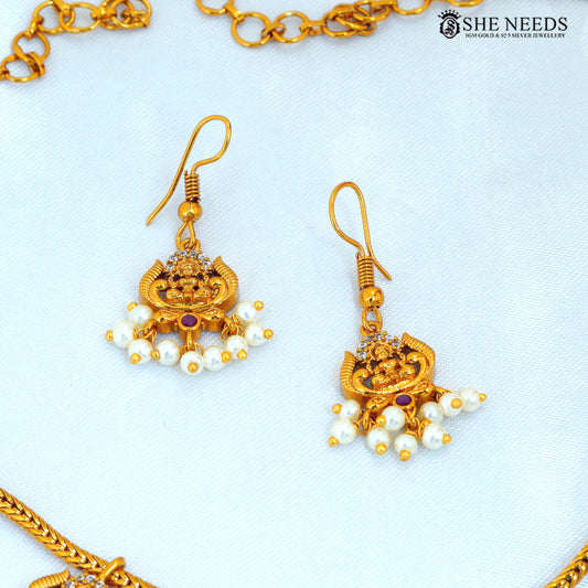 Lakshmi Devi gold polish earrings with ruby stone and white pearl drops, traditional temple jewellery design|She Needs Jewellery
