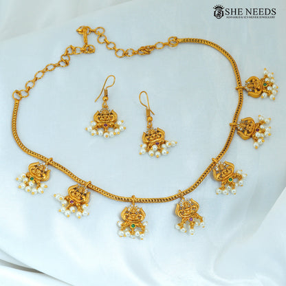 Lakshmi Devi pearl haram necklace with matching earrings, gold polish temple jewellery with traditional goddess motifs and colourful stones|She Needs Jewellery
