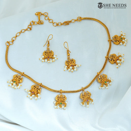 Lakshmi Devi pearl haram necklace with matching earrings, gold polish temple jewellery with traditional goddess motifs and colourful stones|She Needs Jewellery
