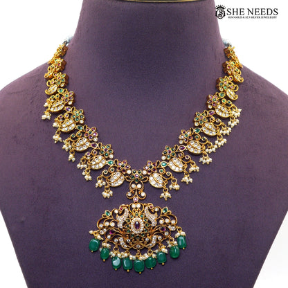 Close-up of Lakshmi pendant necklace with green beads, pearl drops and intricate stonework|She Needs Jewellery
