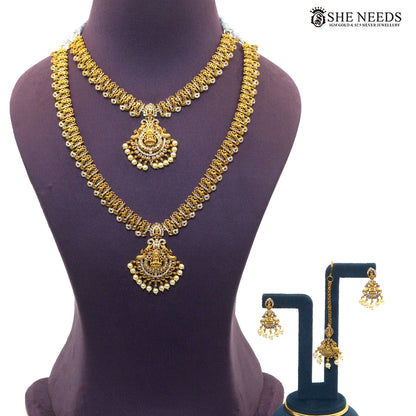 Lakshmi Pearl Cascade antique gold layered necklace set with short and long necklaces, matching earrings and maang tikka|She Needs Jewellery

