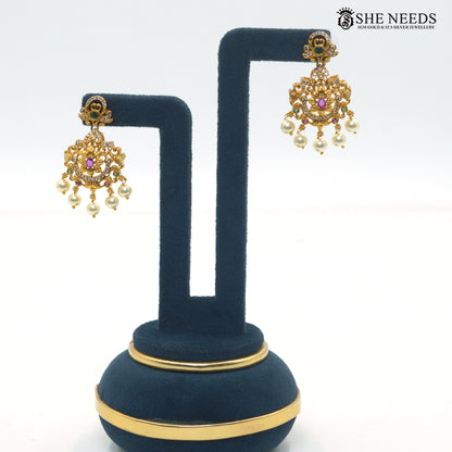 Matching antique gold Lakshmi temple earrings with colorful stones and pearl drop detailing|She Needs Jewellery
