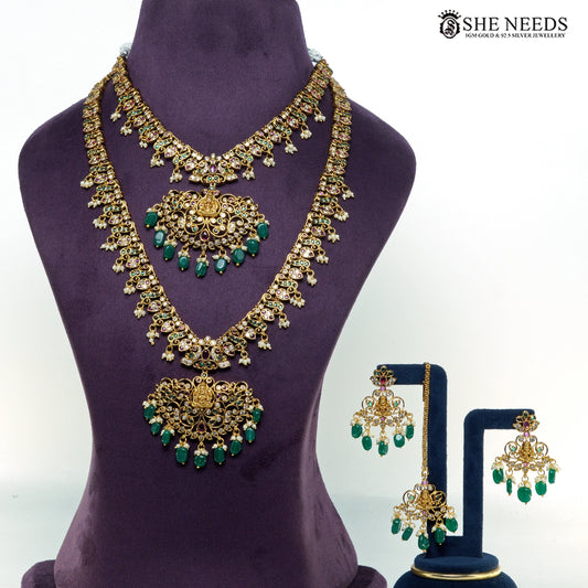 Lakshmi temple jewellery set with layered gold-plated necklaces, green bead drops, ruby-tone stones, pearl accents and matching earrings|She Needs Jewellery
