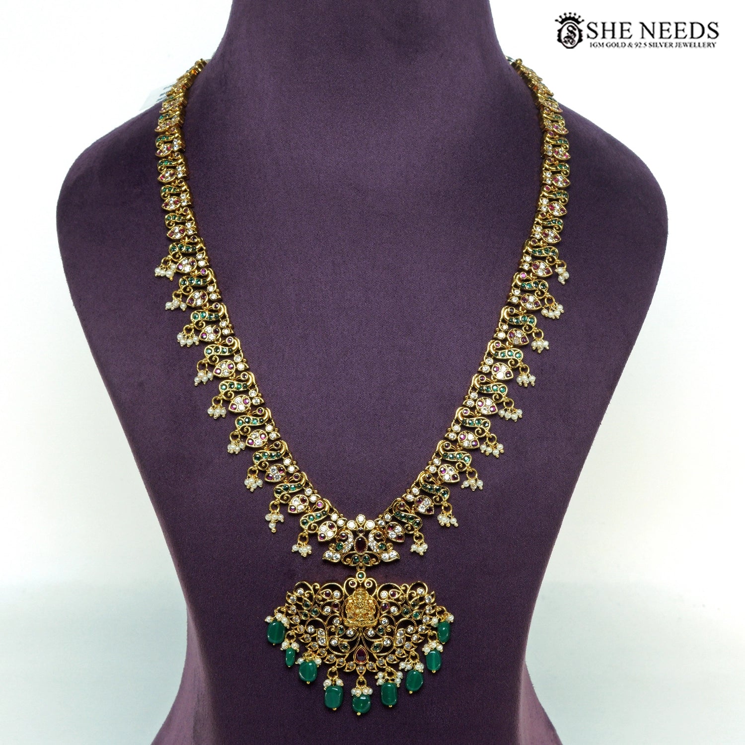 Traditional Lakshmi temple long necklace with intricate gold-plated filigree, green beads, ruby-tone stones and pearl drops|She Needs Jewellery