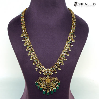 Traditional Lakshmi temple long necklace with intricate gold-plated filigree, green beads, ruby-tone stones and pearl drops|She Needs Jewellery