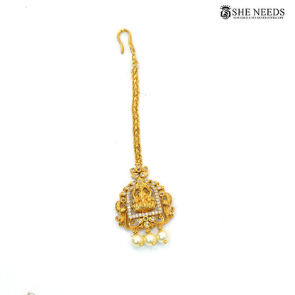 Traditional Lakshmi maang tikka with AD stones, green and ruby accents and pearl drops|She Needs Jewellery
