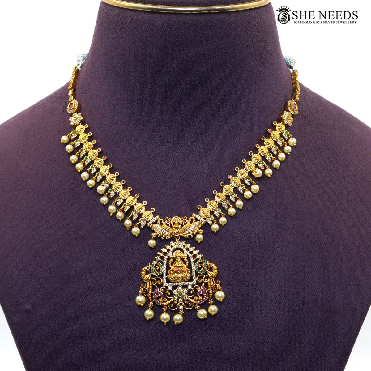 Close-up of Lakshmi temple necklace with detailed gold motifs, AD stones and pearl drops|She Needs Jewellery
