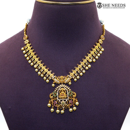 Close-up of Lakshmi temple necklace with detailed gold motifs, AD stones and pearl drops|She Needs Jewellery
