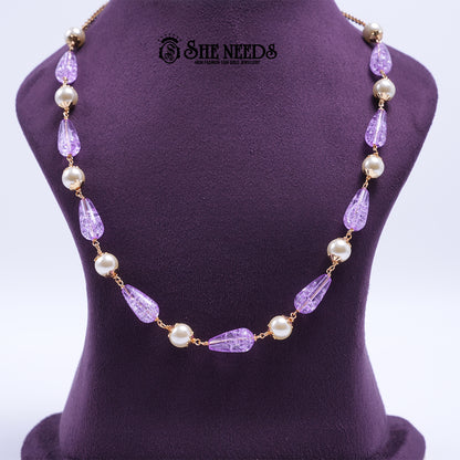 Lavender Pearl Elegance Necklace featuring faceted lavender crystal beads, pearl accents, and elegant gold-tone detailing.|She Needs Jewellery
