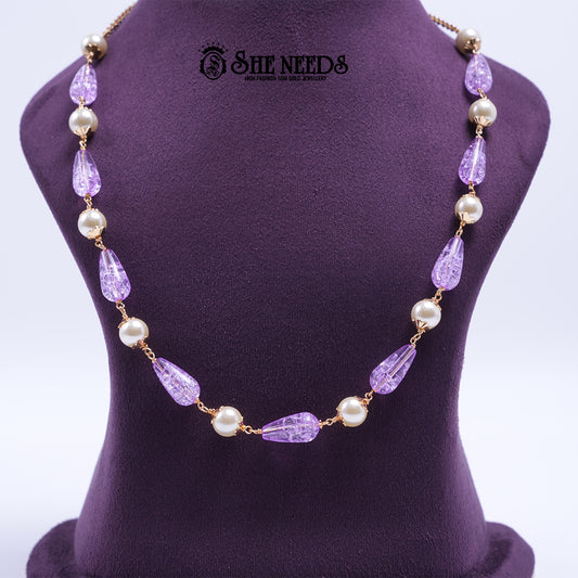 Lavender Pearl Elegance Necklace featuring faceted lavender crystal beads, pearl accents, and elegant gold-tone detailing.|She Needs Jewellery
