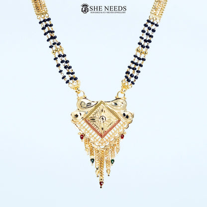 Close-up of Mayuri Gold Plated Traditional Mangalsutra featuring a diamond-shaped engraved pendant with floral detailing, tassel danglers, and a black bead chain.|She Needs Jewellery
