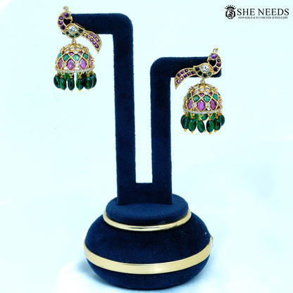 Pair of Mayurika Antique Gold Peacock Feather Jhumka Earrings with Green Beads, ruby-colored stones and American Diamonds.|She Needs Jewellery
