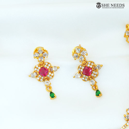 Close-up of multicolor floral gold-plated earrings with ruby, green and white stones|She Needs Jewellery
