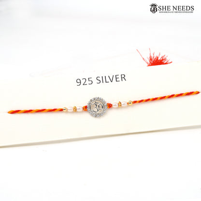Om Divine 925 silver Rakhi with pearl beads, sparkling stones and red-yellow braided thread|She Needs Jewellery
