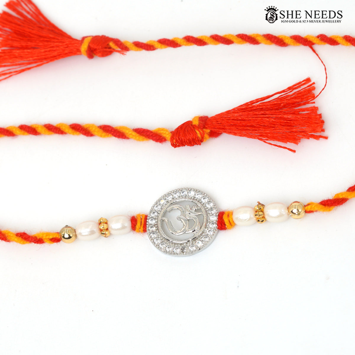 Om Radiance 925 silver Rakhi with pearl beads, sparkling stones and red-yellow braided thread|She Needs Jewellery

