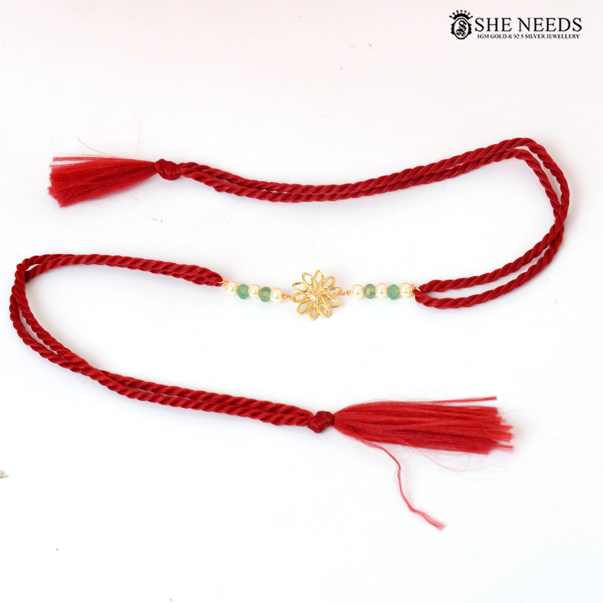 Traditional Red Thread Silver Rakhi with Green Beads & Floral Gold Motif