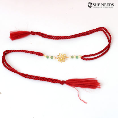 Traditional Red Thread Silver Rakhi with Green Beads & Floral Gold Motif