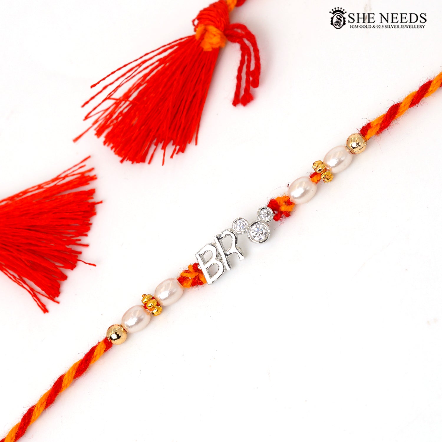 925 silver Rakhi with red and yellow braided thread, pearl beads, sparkling stones and BRO center charm.