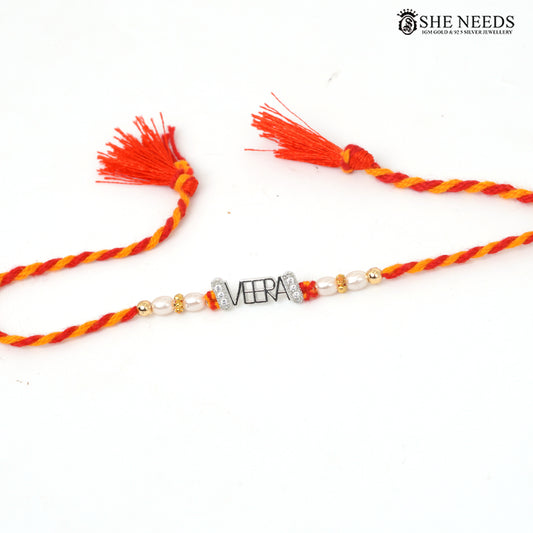 925 silver VEERA name Rakhi with pearl beads, sparkling stone accents and red-yellow braided thread.