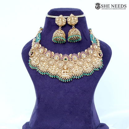 Temple gold Lakshmi choker set with emerald green beads and matching jhumka earrings by She Needs Jewellery