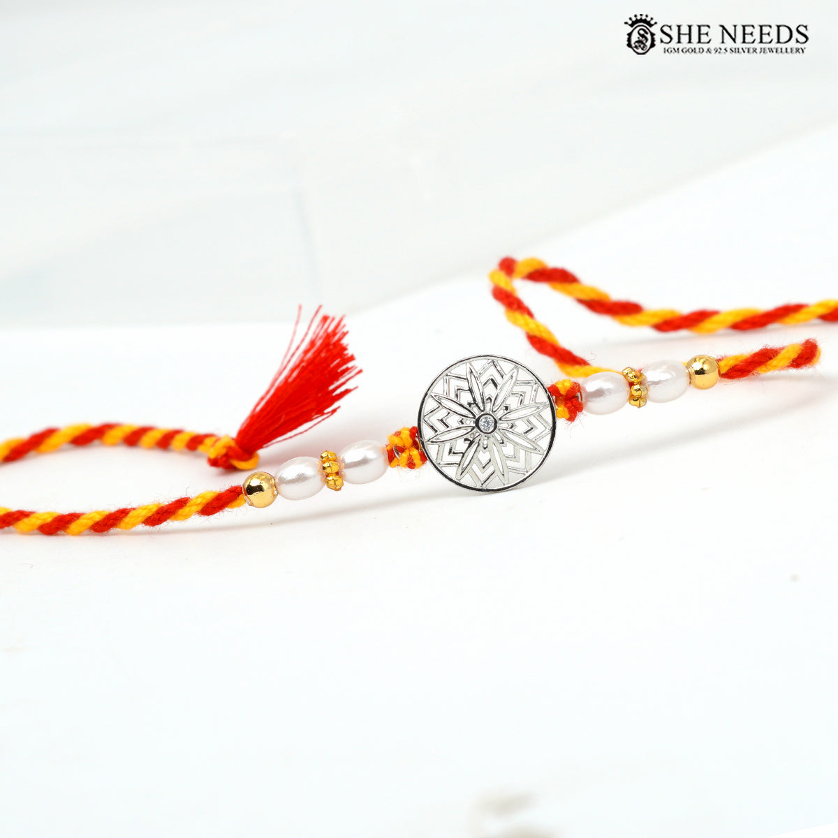 Silver Floral Mandala Rakhi with Pearl Beads & Red Yellow Thread
