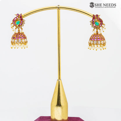 Peacock design gold temple jhumkas with pink stones and pearl drops by She Needs Jewellery