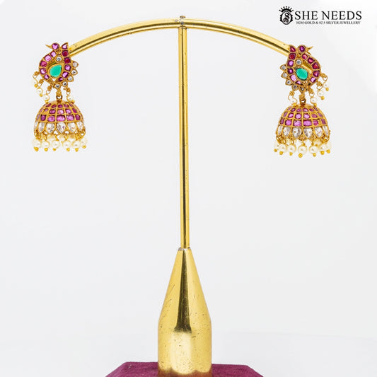 Peacock design gold temple jhumkas with pink stones and pearl drops by She Needs Jewellery