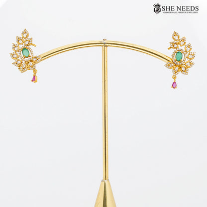Gold finish floral CZ stud earrings with green stone – She Needs Jewellery
