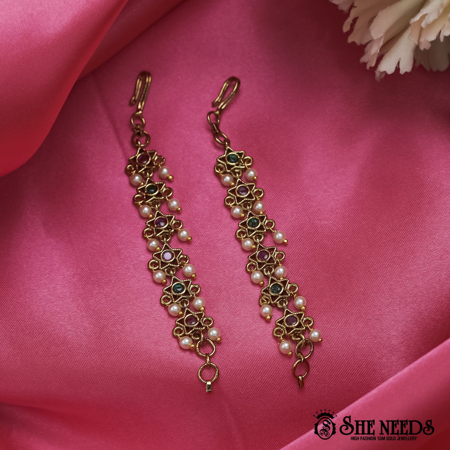 Antique gold Pearl Star Matilu featuring star-shaped kemp stone motifs, green and ruby accents, and delicate pearl embellishments arranged in a traditional South Indian ear chain design.|She Needs Jewellery
