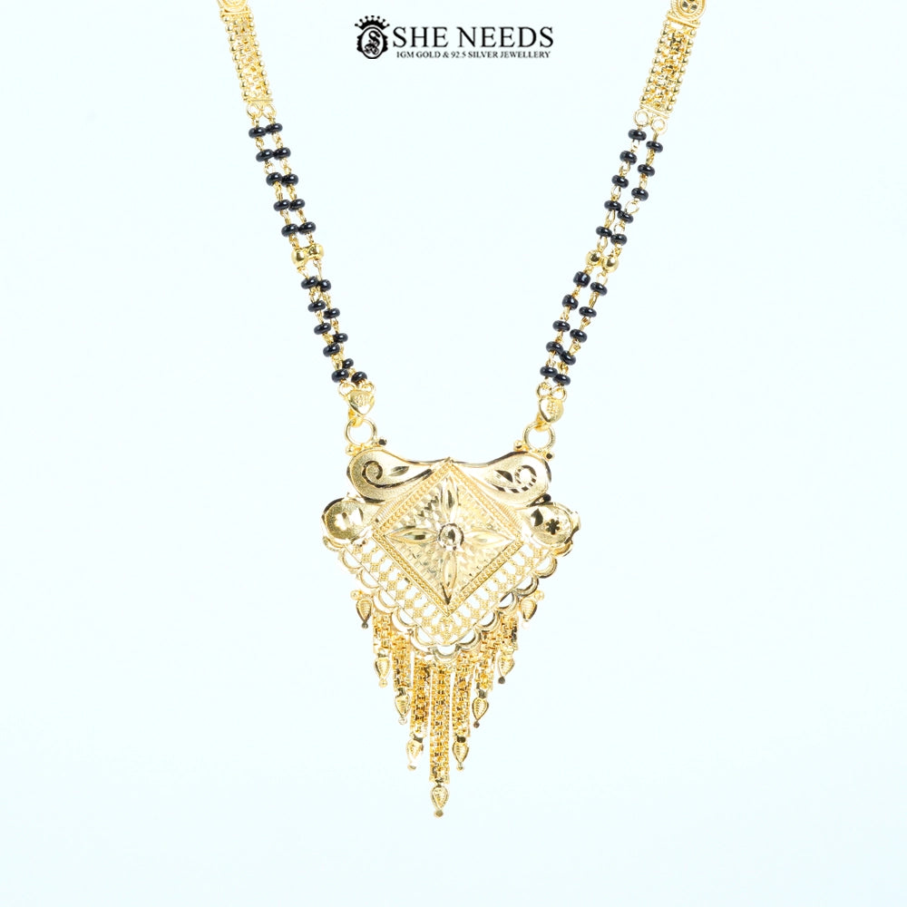 Close-up of Pranavi Gold Plated Traditional Mangalsutra featuring an engraved diamond-shaped pendant with floral detailing, lattice work, tassel charms, and a classic black bead chain.|She Needs Jewellery

