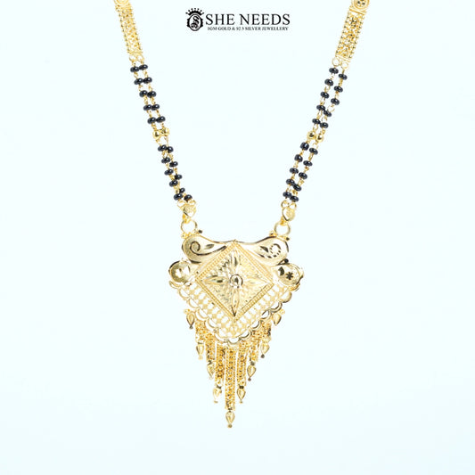 Close-up of Pranavi Gold Plated Traditional Mangalsutra featuring an engraved diamond-shaped pendant with floral detailing, lattice work, tassel charms, and a classic black bead chain.|She Needs Jewellery
