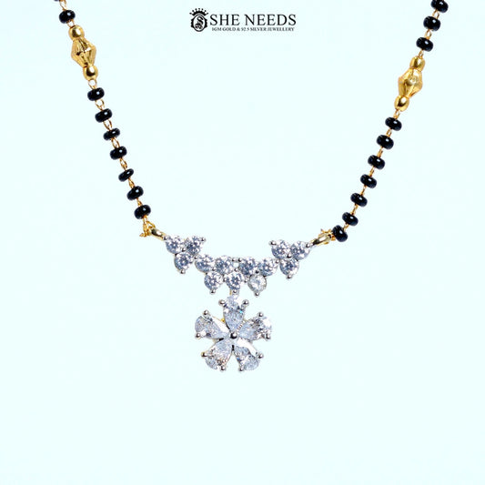 Close-up of Pushpanjali Gold Plated AD Floral Mangalsutra showcasing an American Diamond floral pendant with butterfly-inspired vine accents and black bead chain.|She Needs Jewellery
