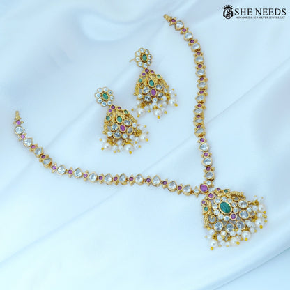 Full view of Pushpika Gold Plated American Diamond Floral Necklace Set with matching pearl jhumka earrings featuring brilliant CZ stones, green and ruby accents, and pearl drop detailing.|She Needs Jewellery
