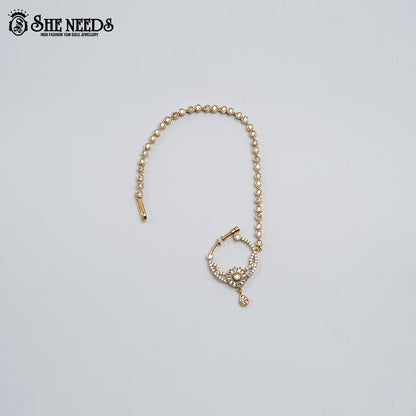 Radiant CZ Nose Ring with Chain featuring a floral-inspired cubic zirconia design, gold finish, and elegant stone-studded chain.|She Needs Jewellery
