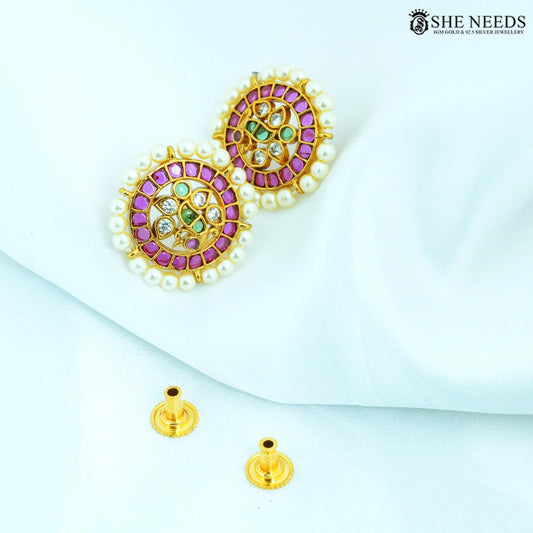 Pair of Ratnashri Antique Gold Pearl Floral Stud Earrings featuring ruby-colored stones, emerald-colored stones, American Diamonds and pearl border.|She Needs Jewellery
